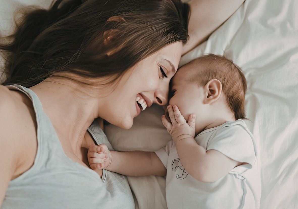 New mother resting with baby nearby — postpartum emotional wellbeing and recovery
