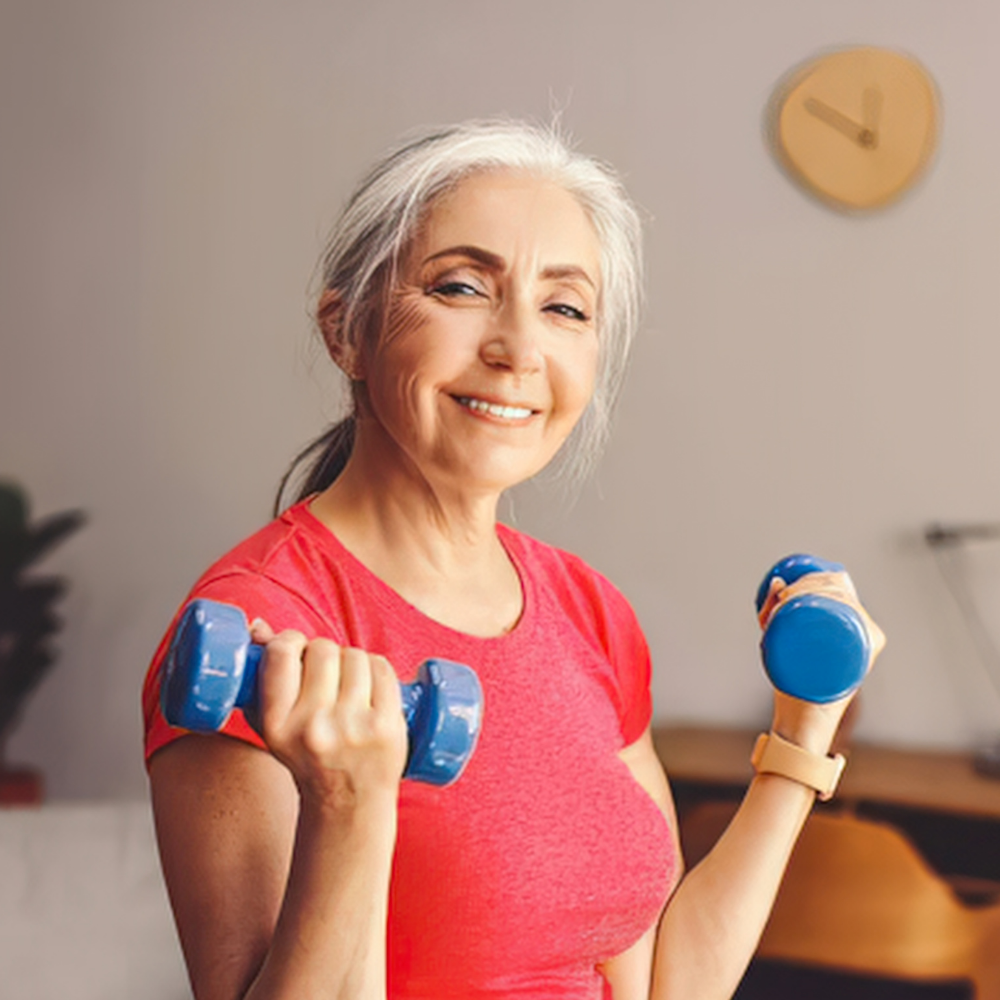 Woman strength training at the gym while managing menopause joint pain